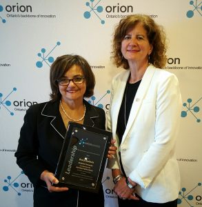 Kathryn Anthonisen, Vice-President, External Relations, CANARIE, presents Brock Dubbels with the 2016 ORION Innovation Leadership Award. Brock was not present, and the award was accepted on his behalf by Sherry Fahim, Director Digital Technology and Creation, Hamilton Public Library